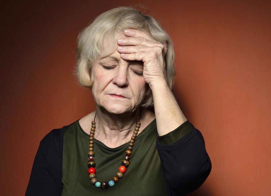 Older woman holding head in distress